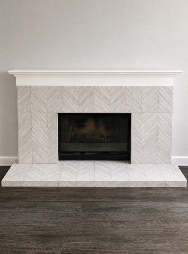 Fireplace surround set in herringbone marble tile with a wood-look plank floor