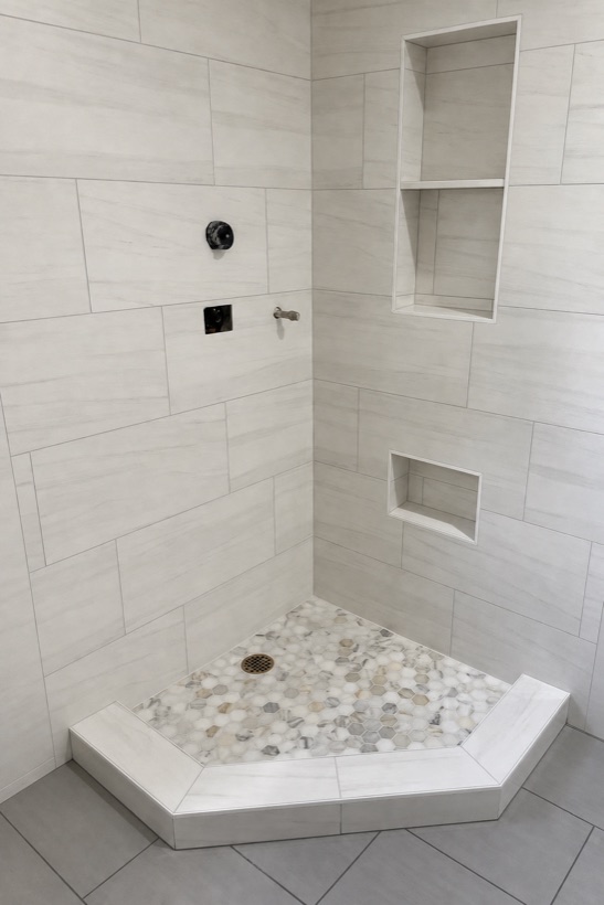 Neo-angle shower with pebble mosaic floor
