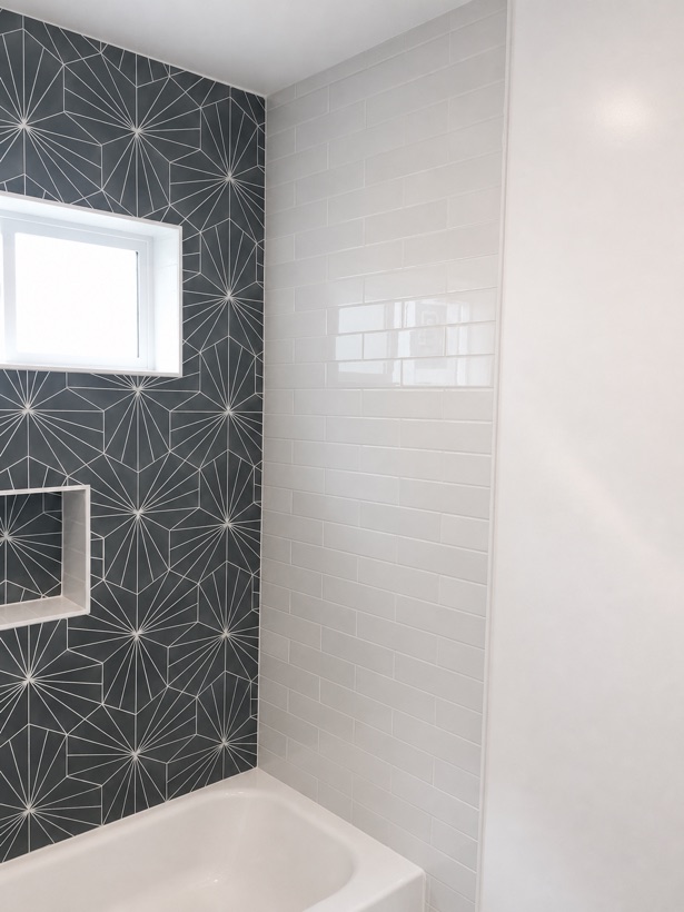 Shower with a starburst tile accent wall
