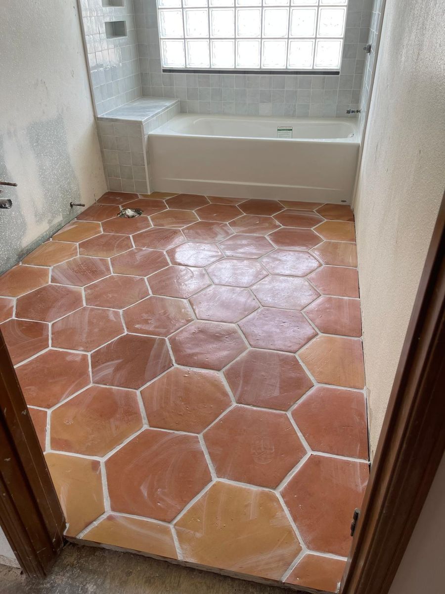 Newly laid saltillo-style terracotta hexagon floor in a bathroom